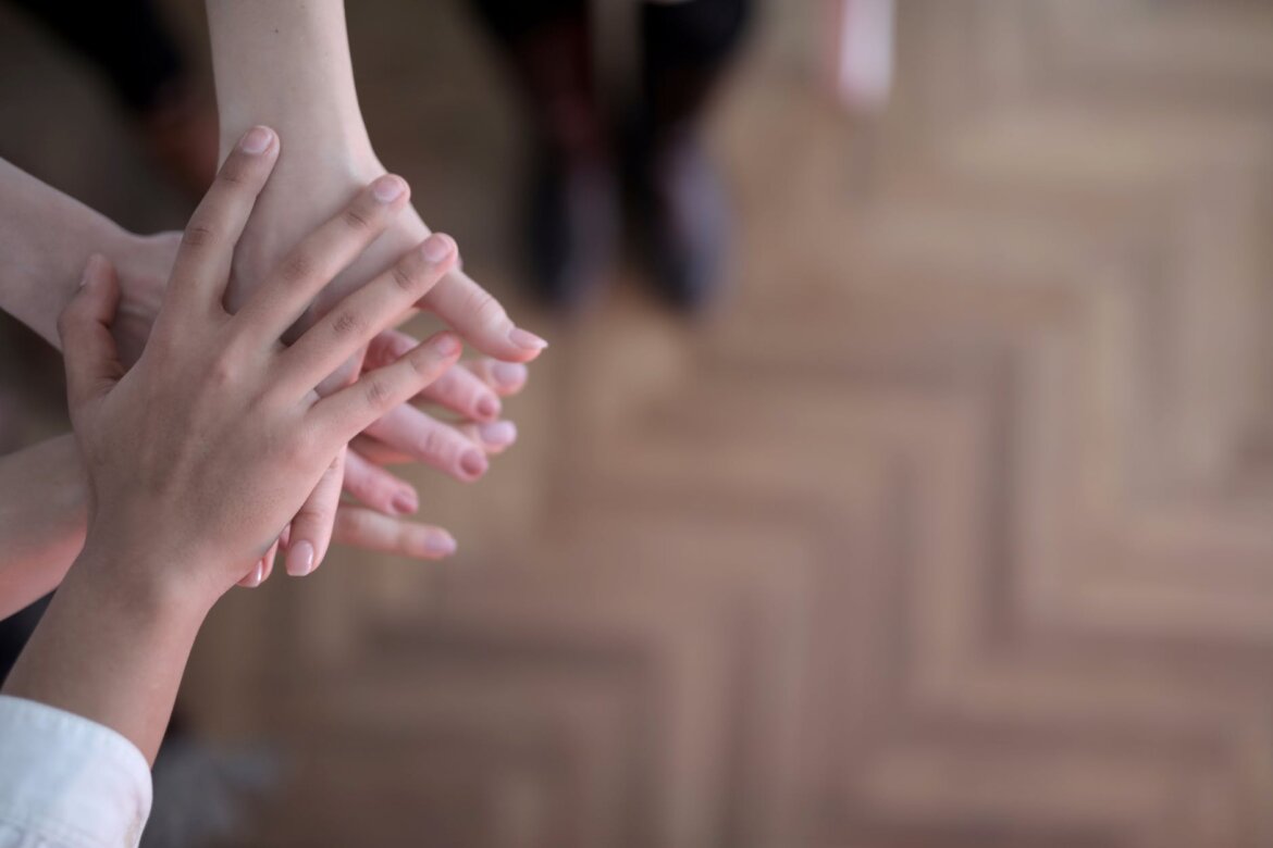 pexels-photo-3830745 crop group stacking hands together