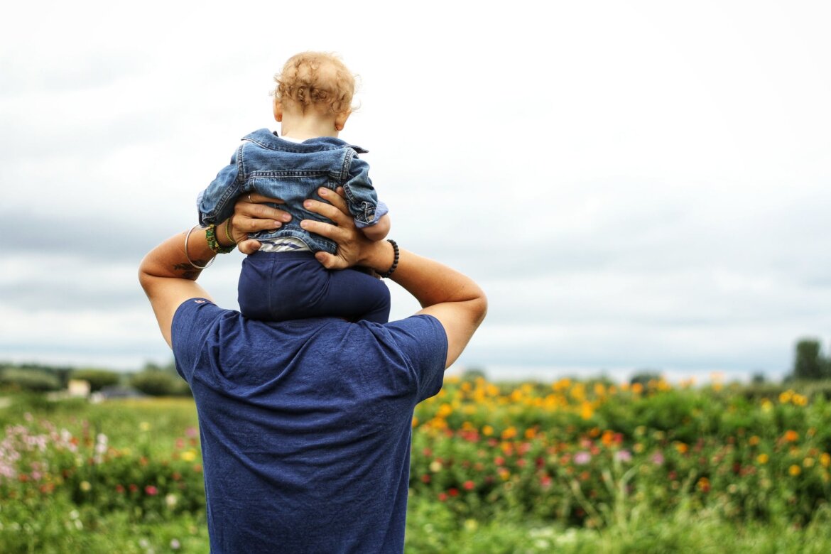 pexels-photo-1497394 baby sitting on man s shoulder