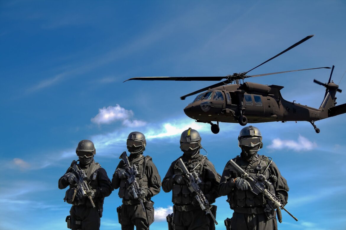 pexels-photo four soldiers carrying rifles near helicopter under blue sky