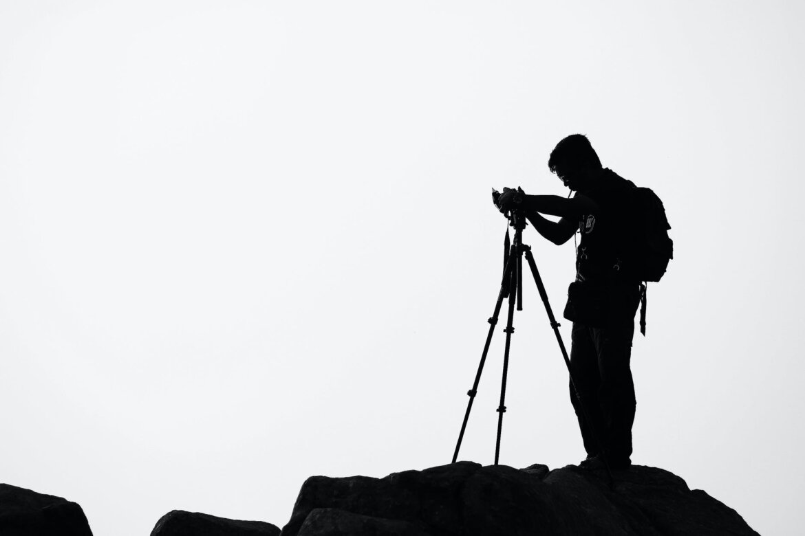 silhouette of man holding camera